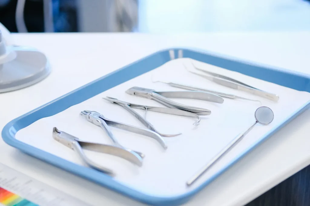 Stainless steel fork and bread knife on white ceramic plate